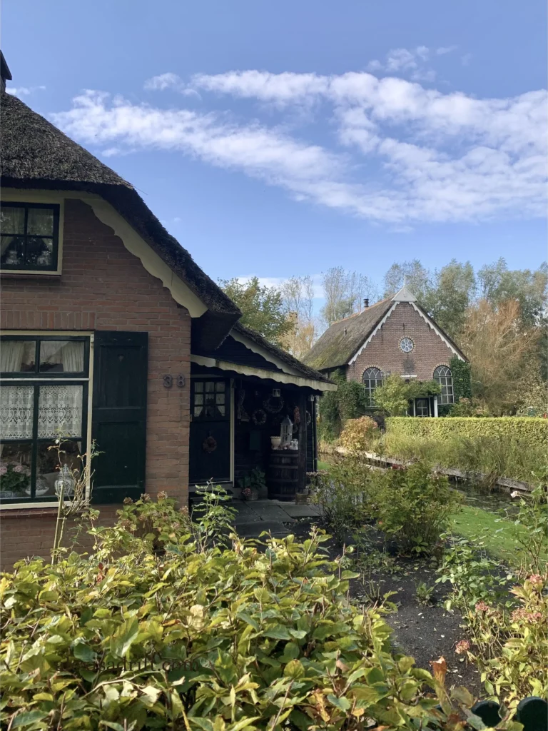 Giethoorn, Netherlands. Cottage and church with garden.